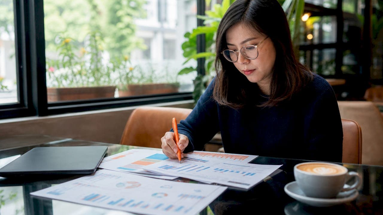 Woman analyzing SEO ranking reports at desk
